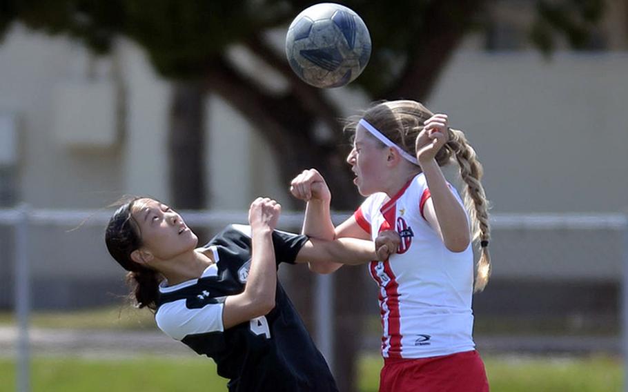 Nile C. Kinnick's Bree Withers heads the ball in front of Zama's Sakura Lopez during Saturday's DODEA-Japan soccer match. The Red Devils won 2-0.