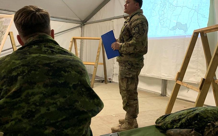 U.S. Army Sgt. First Class Shawn Childers, a fires advisor assigned to 4th Security Forces Assistance Brigade, briefs Scheme of Fires during the Allied Spirit 22 Brigade operations order brief at the Joint Multinational Readiness Center in Hohenfels, Germany, Jan. 20, 2022. 
