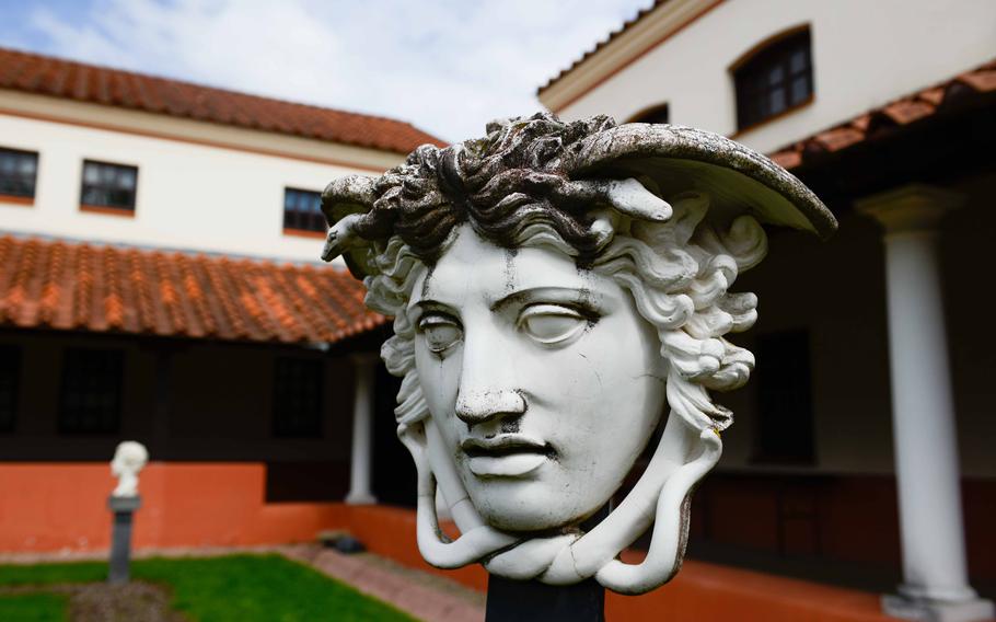 A Roman mask decorates the courtyard garden at Roman Villa Borg in Borg, Germany. Visitors will see artifacts and reconstructed art work throughout the gardens and small orchard surrounding the villa.