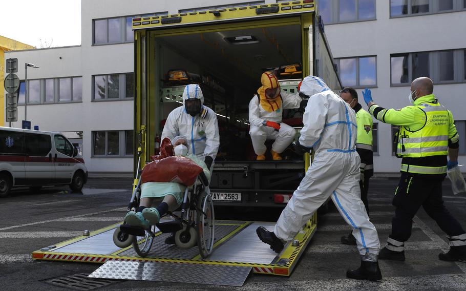 Health care workers transport a COVID-19 patient, in Ceska Lipa, Czech Republic, Thursday, March 18, 2021. Coronavirus infections in the Czech Republic have soared to a record level again, reaching almost 26,000 daily cases. The Health Ministry says the daily tally hit 25,864 on Tuesday, Nov. 23, 2021, about 3,000 more than the previous record registered on Friday.