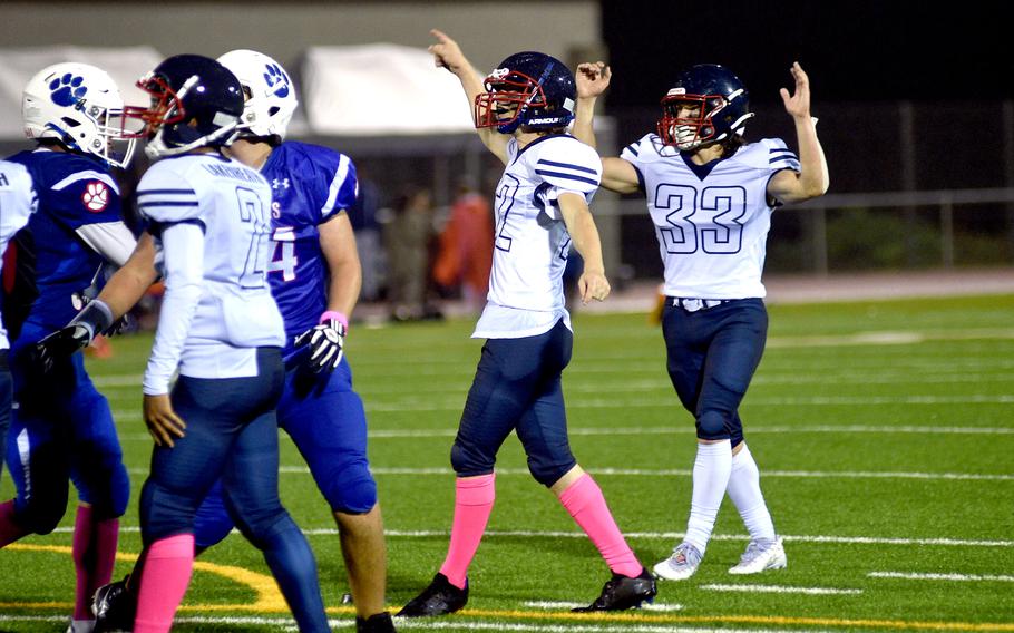 Lakenheath kicker Matthew Donalds, center, and teammate Gavin Idleman, right, celebrate his 20-yard field goal Friday evening in Ramstein, Germany.