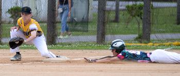 Kadena third baseman Gavin McGlinchy takes the throw as Kubasaki's Andrew Welte slides into third base during Friday's Okinawa baseball game. The Dragons won 19-0.