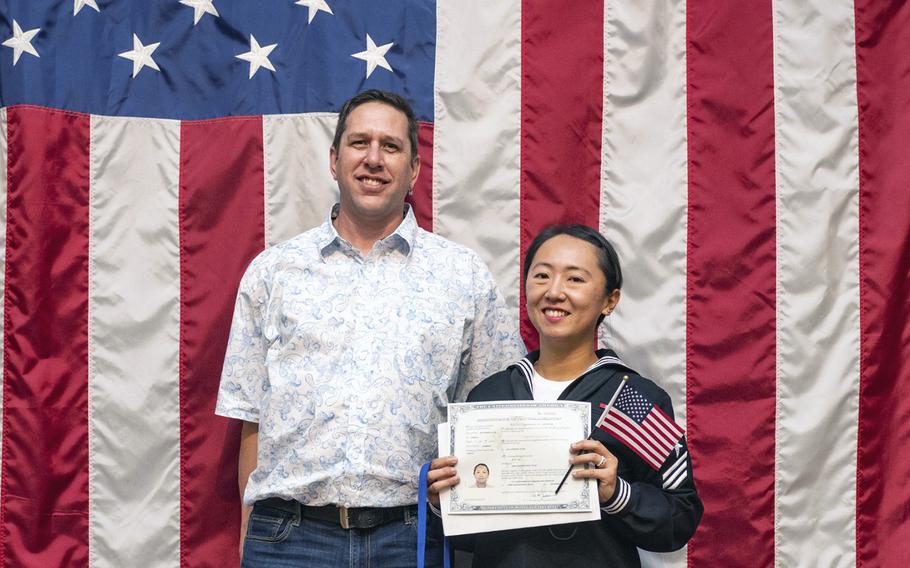 Navy Seaman Jung Tai stands beside her husband, retired Sgt. 1st Class Jesse Brown during a ceremony at Joint Base San Antonio-Fort Sam Houston, Texas., on Dec. 15, 2021. According to reports on Friday, March 3, 2023, officials at Naval Air Station Meridian in Mississippi named Tai the base’s Military Citizen of the Year.