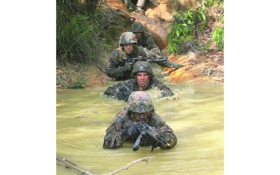 Camp Gonsalves, Okinawa, March 17, 2015: Marines from India Company's Weapons Platoon enter a pool of murky jungle water during the Jungle Warfare Training Center's E-Course. After the training in boot-sucking mud and thick jungle foliage, the Marines from 3rd Battalion, 2nd Marine Regiment will endure the cold, mountainous terrain of Camp Fuji in Japan, followed by the hot and humid South Korean summer when they will be training at the Rodriguez live-fire range to finish off the 6-month Unit Deployment Program. 

META TAGS: U.S. Marine Corps; USMC; Training; exercise; 