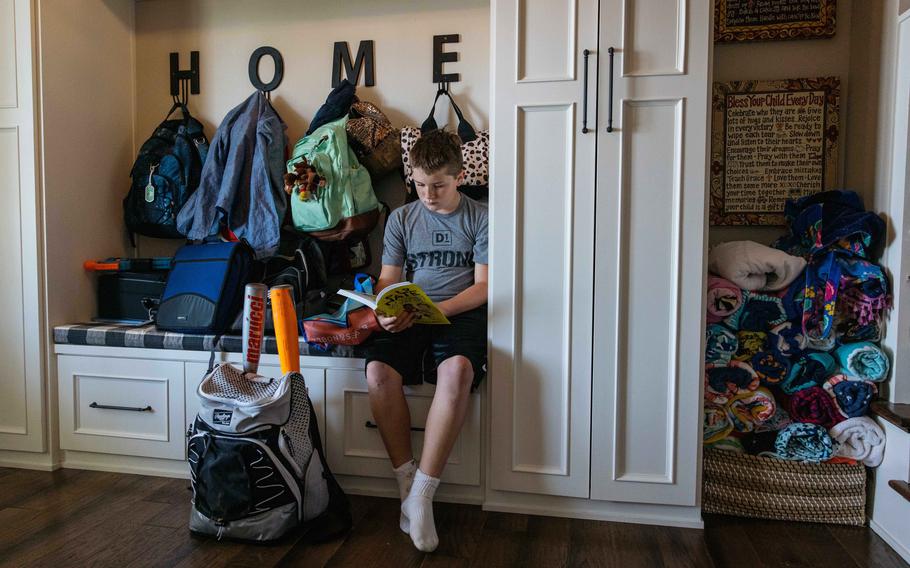 Whitman Stacey, younger brother to Annalise Stacey, reads a graphic novel after school. 