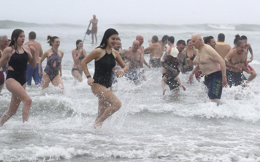 Beachgoers take part in the Brigantine Polar Bear Plunge in New Jersey on New Year’s Day, Jan. 1, 2022.