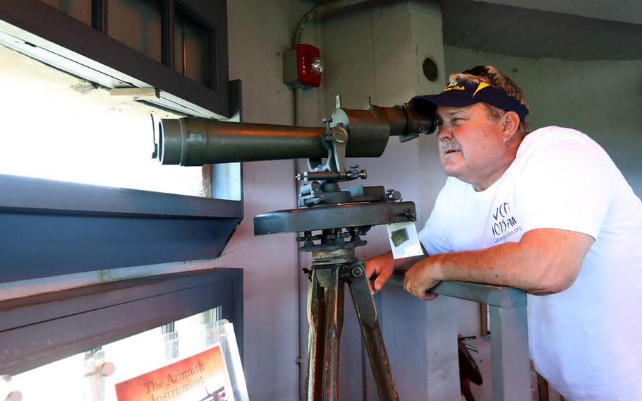 Mark Allen, a local historian, looks through the azimuth atop Fire Control Tower No. 23, in Lower Township, N.J., June 1, 2022. It was built in 1942 for use during World War II.