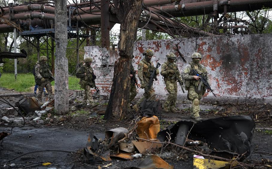 Russian troops walk in a destroyed part of the Illich Iron & Steel Works Metallurgical Plant in Mariupol, in territory under the government of the Donetsk People's Republic, eastern Ukraine, on May 18, 2022. Even as the Russian war machine crawls across Ukraine’s east, trying to achieve the Kremlin’s goal of securing a full control over the country’s industrial heartland of the Donbas, the Ukrainian forces are scaling up attacks to reclaim territory in the south. 