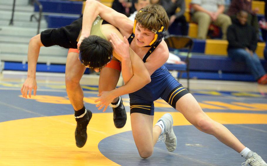 Yokota 127-pounder Evan Horne and St. Mary's Luke Shane battle for control during Wednesday's Kanto Plain dual meet. Shane won a 10-7 decision and the Titans won the meet 40-18.