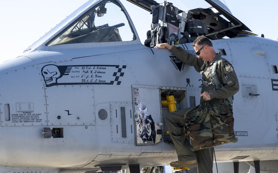 An airman climbs inside an aircraft