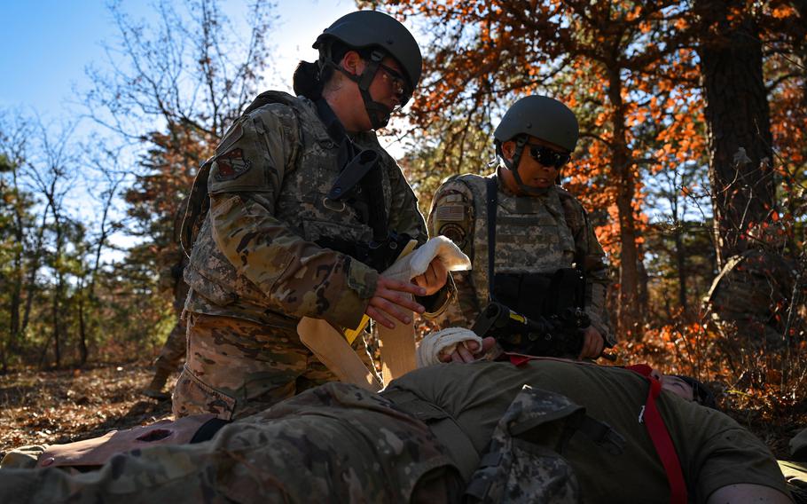 U.S. Air Force Public Health Instructor Technical Sgt. Anastasia Visona, from United States Air Force School of Aerospace Medicine,  and Staff Sgt. Brian Rosales, perform bleeding control and first aid procedures on a training victim during Tactical Combat Casualty Care training at Joint Base McGuire-Dix-Lakehurst, New Jersey, Nov. 18, 2021. Kettering Health, the parent company of Soin Medical Center in Beavercreek, Ohio, and the USAF School of Aerospace Medicine have partnered to create the Peerless Technologies Corporation Critical Care Training Center at the hospital.
