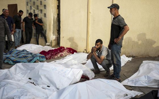 Palestinians mourn their relatives killed in the Israeli bombardments of the Gaza Strip in front of the morgue of the Al Aqsa Hospital in Deir al Balah, Gaza Strip, on Saturday, May 11, 2024. (AP Photo/Abdel Kareem Hana)