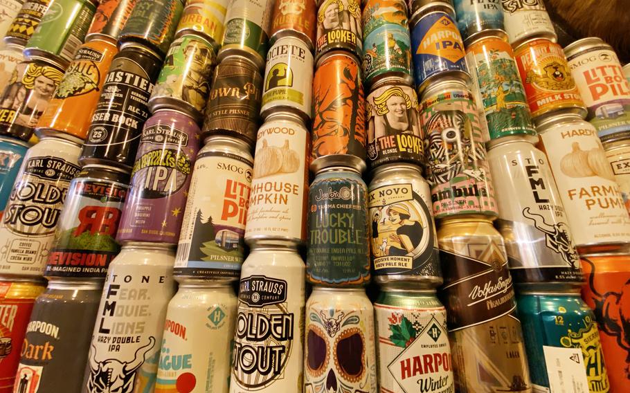 A wall of electic beer cans is stacked high.