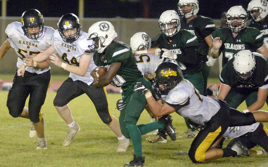 Kubasaki running back Godfrey Wray gets chased down by Kadena's Joey Puterbaugh, Andrew Vessely and Conner Burgess.