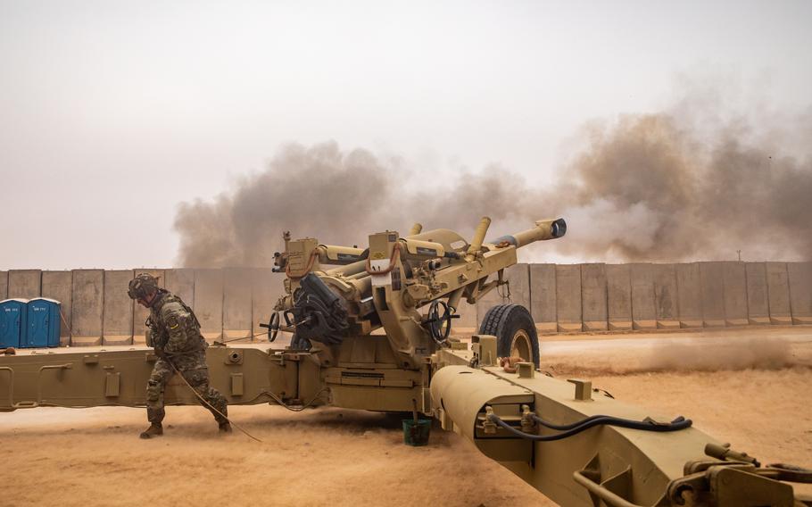 Brig. Gen. Michael Ecker fires an M198 155mm howitzer during an artillery live-fire exercise at al-Asad air base in Iraq on Dec. 20, 2023. 