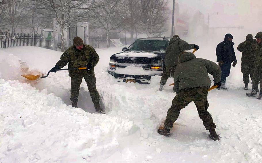 Members of the New York Air National Guard assigned to the 107th Attack Wing at Niagara Falls Air Reserve Station assist motorists stuck in high snow drifts near Buffalo, New York December 25, 2022.