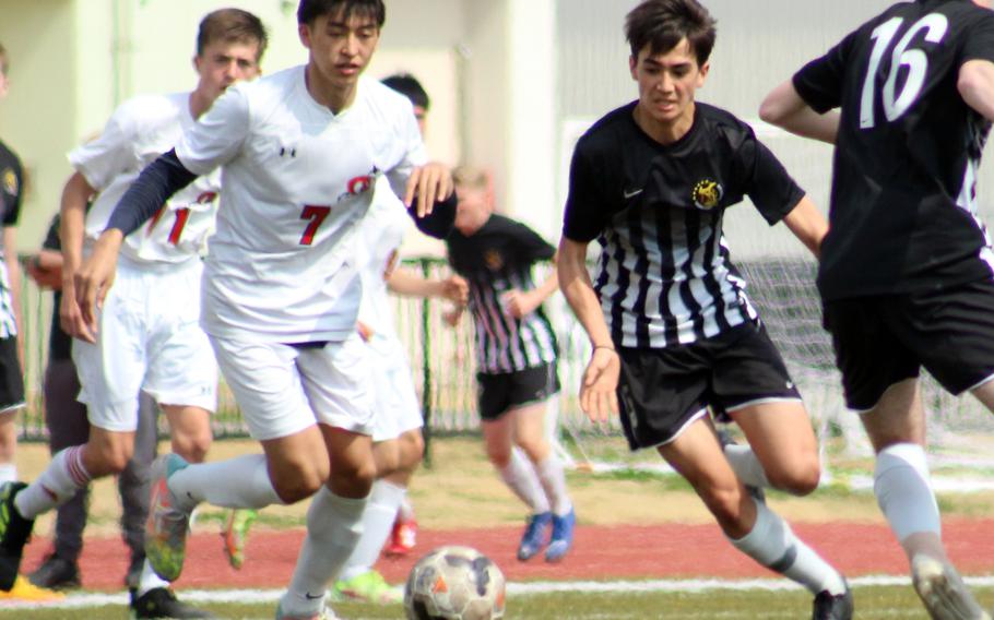 E.J. King's Kaito Bergman and Matthew C. Perry's John Shaver chase the ball during Saturday's DODEA-Japan soccere match. The Samurai won 4-2.