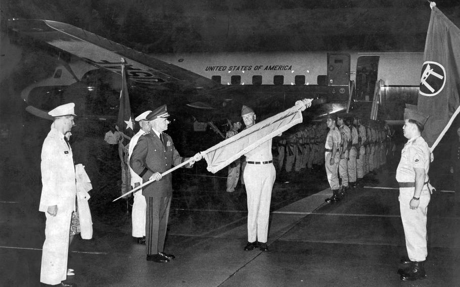 Army Lt. Gen. James Lampert, the last U.S. high commissioner in Okinawa, is presented with the flag of the high commissioner of the Ryukyu Islands, a post he held since 1969, just before boarding a flight to Tokyo, May 15, 1972. The general  left Okinawa 16 minutes after the reversion of Okinawa took effect, returning the prefecture to Japan after 27 years of U.S. rule.