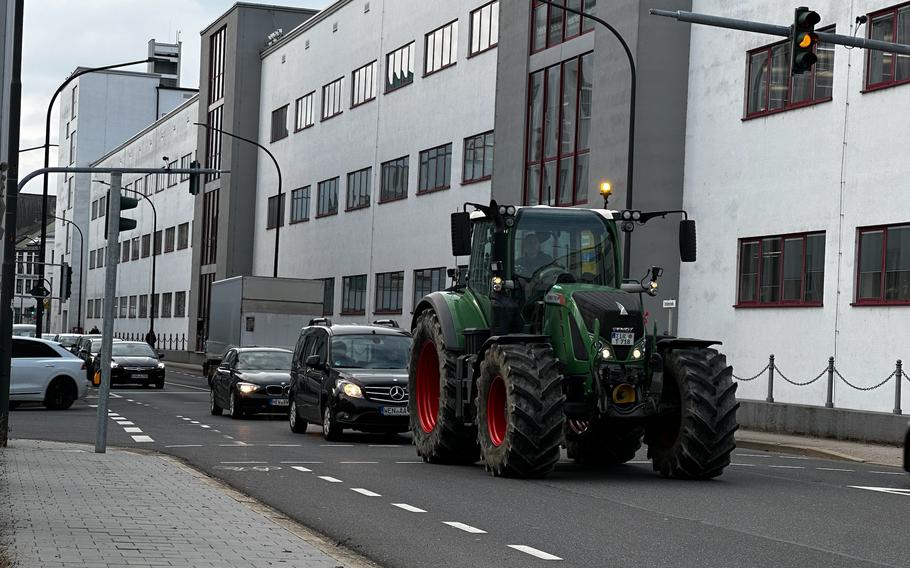 A farmer blocks traffic by slowly driving through downtown Weiden, Germany, Jan. 8, 2024. Farmers throughout Germany are protesting agricultural legislation that included the proposed removal of diesel fuel subsidies for farm vehicles. 