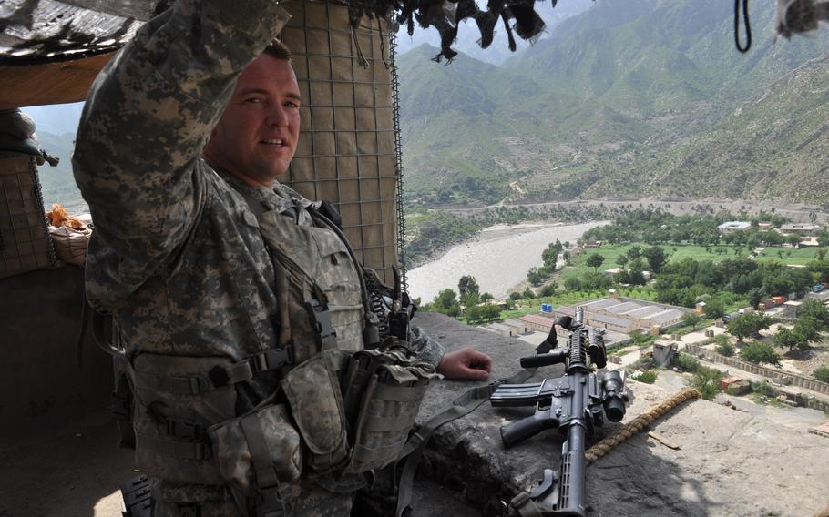 Capt. Jeffrey Hinds, then Company Commander of A Company, 2nd Battalion, 387th Infantry Regiment, is positioned in one of the guard positions at the observation post overlooking COP Monti and the Kunar River.