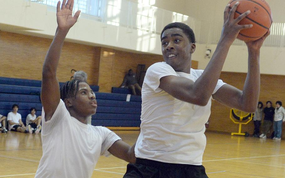 Nile C. Kinnick's boys basketball team hopes to get good production from junior guard Xavier Wright, left, and junior forward Austin Davenport.