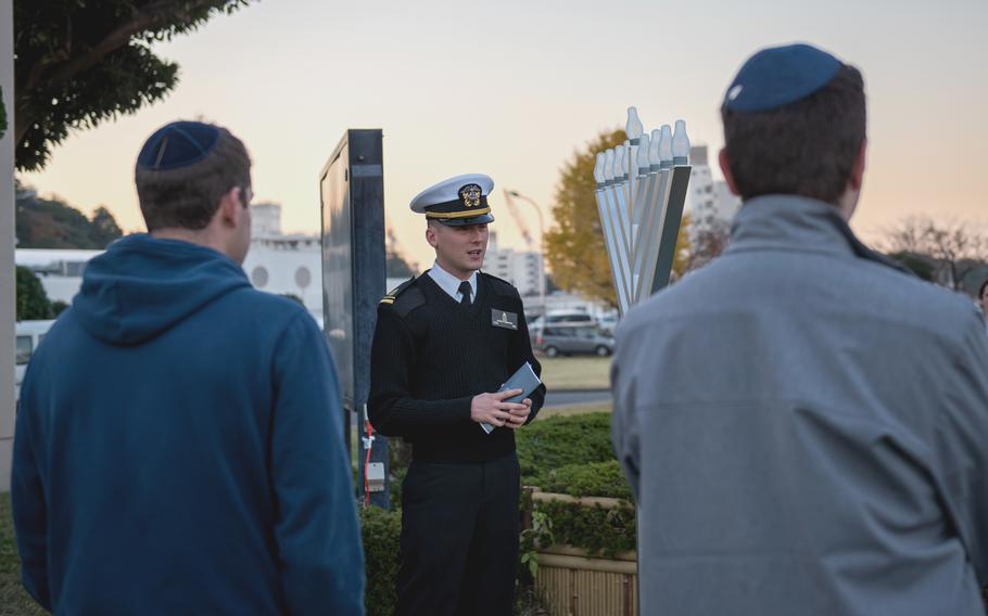 Chaplain Alex Hamilton, a Navy lieutenant junior grade, speaks at a menorah lighting ceremony at Yokosuka Naval Base, Japan, on Dec. 7, 2023.