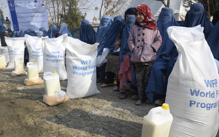 Lena, 7, waits with her mother to receive food from the United Nations World Food Program in Kabul, Afghanistan, Jan. 30, 2020. Groups of U.S. military veterans have been sending food donations to the country in recent months.