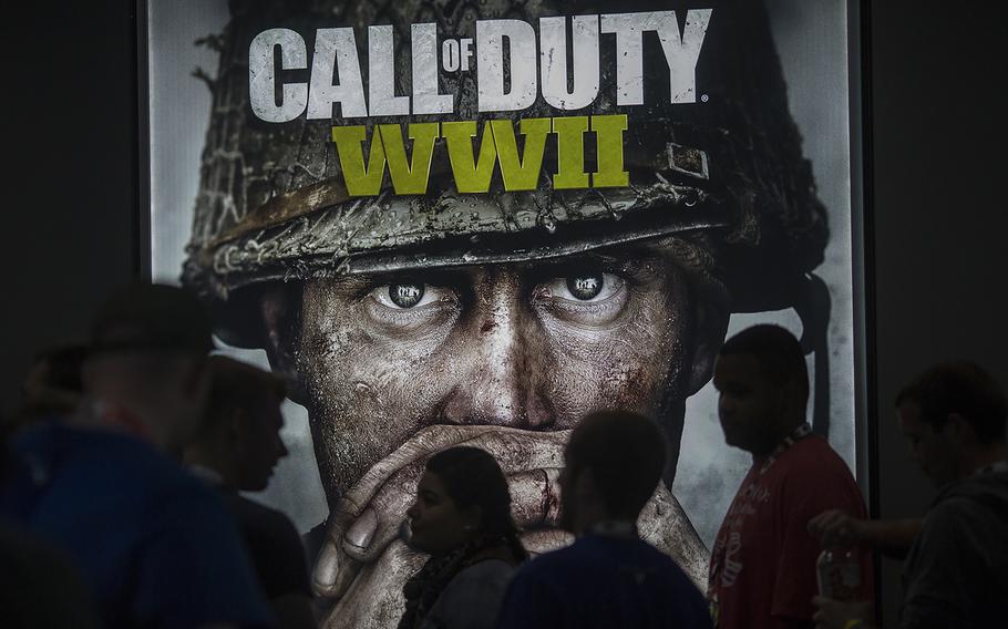 People wait in line of to see a demonstration Call of Duty WWII at the Activision exhibit on opening day of the Electronic Entertainment Expo at the Los Angeles Convention Center on June 13, 2017, in Los Angeles.  