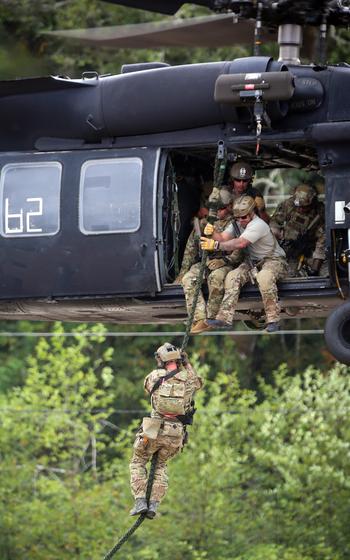 Members of the 10th Special Forces Group combat dive team conduct fast rope insertion training with the 160th Special Operations Aviation Regiment in Astoria, Oregon, Sept. 14, 2021. A judge in Washington state sided with public opposition to the Navy using public parks along the Columbia River for SEAL training, but Army Green Berets have trained across the river in Oregon for decades with little public notice.