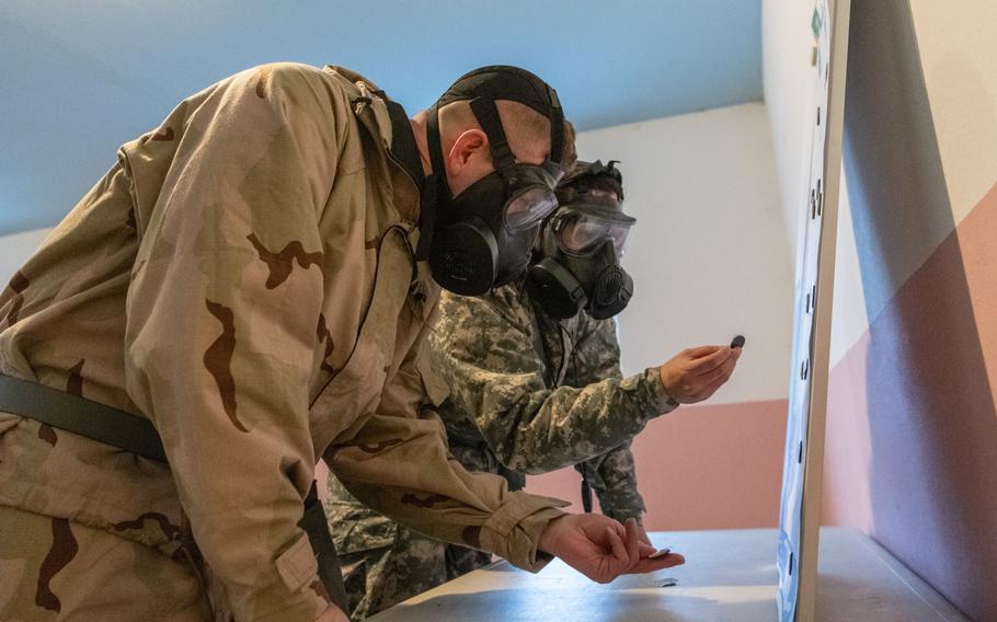 Two American soldiers participate in a medical competition.