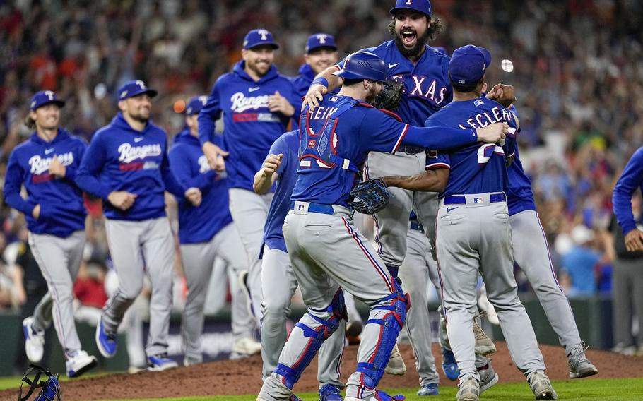 The Texas Rangers celebrate after Game 7 of the baseball AL Championship Series against the Houston Astros Monday, Oct. 23, 2023, in Houston. The Rangers won 11-4 to win the series 4-3. 