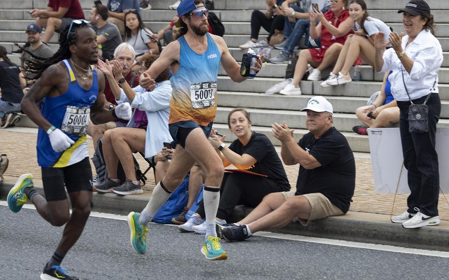 Action near the 10-mile mark of the 48th Marine Corps Marathon on Sunday, Oct. 29, 2023, in Arlington, Va.