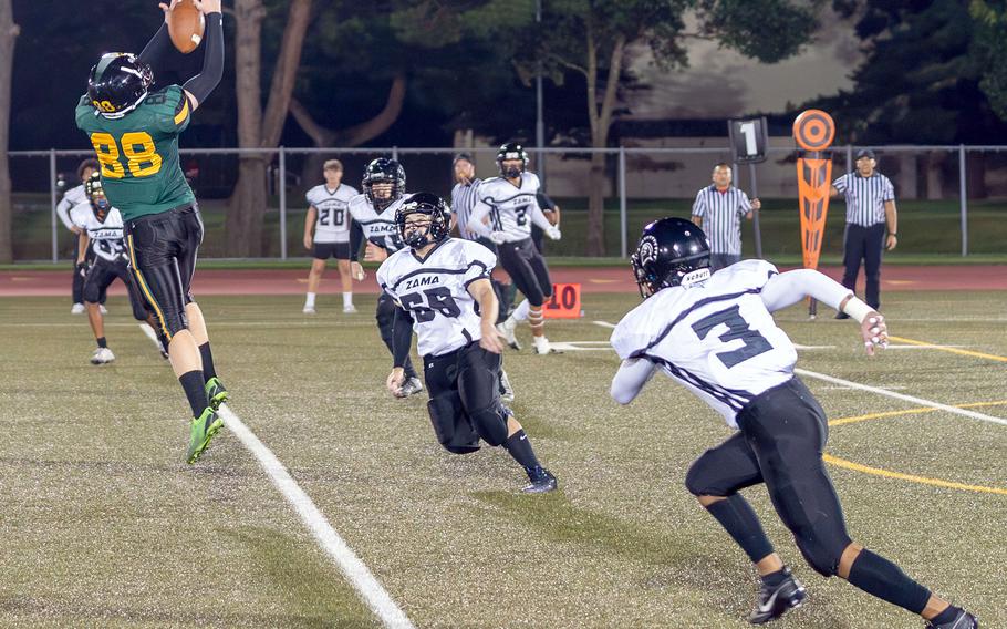 Robert D. Edgren receiver Roman Wells snags a pass as Zama defenders Ayden Moore and Chayden Williams close in.