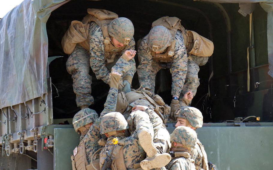 Marines evacuate a mock casualty during the Bushido Strike exercise at Dagmar North Training Area in Paju, South Korea, Tuesday, Feb. 21, 2023.