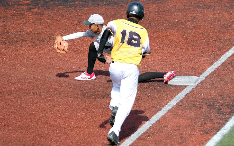 Kubasaki's Luka Koja fields a throw at first base to put out Kadena baserunner Tony Wilson.