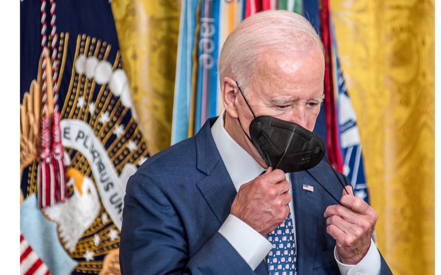 President Joe Biden during a ceremony at the White House on Tuesday, Sept. 5, 2023, removes his face mask after arriving for a Medal of Honor ceremony for retired Army helicopter pilot Capt. Larry Taylor who received the nation’s highest military award for valor for his heroic actions during the Vietnam War when he led a mission in 1968 to save a small group of soldiers trapped in a rice field by enemy fire.  