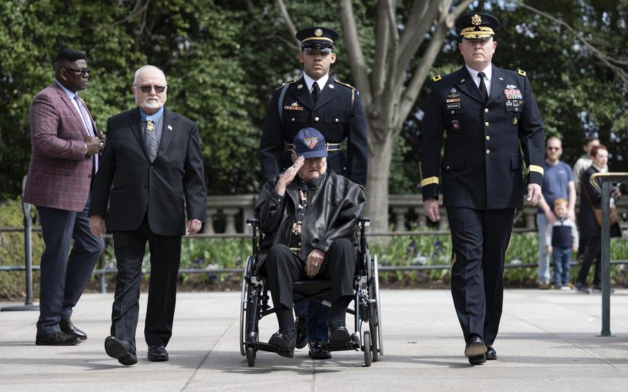 A man in a wheelchair salutes