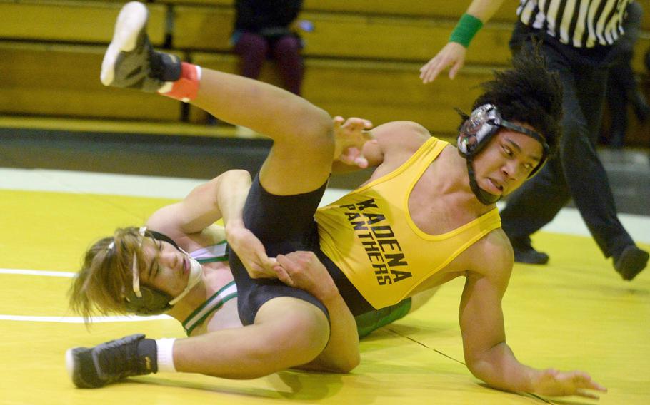 Kubasaki's Adrian Misenhimer employs a crotch lift on Kadena's Jeremiah Drummer at 168 pounds during Wednesday's Okinawa wrestling dual meet. Drummer won by technical fall 15-4 in 4 minutes, 5 seconds and the Panthers won the meet 30-28.