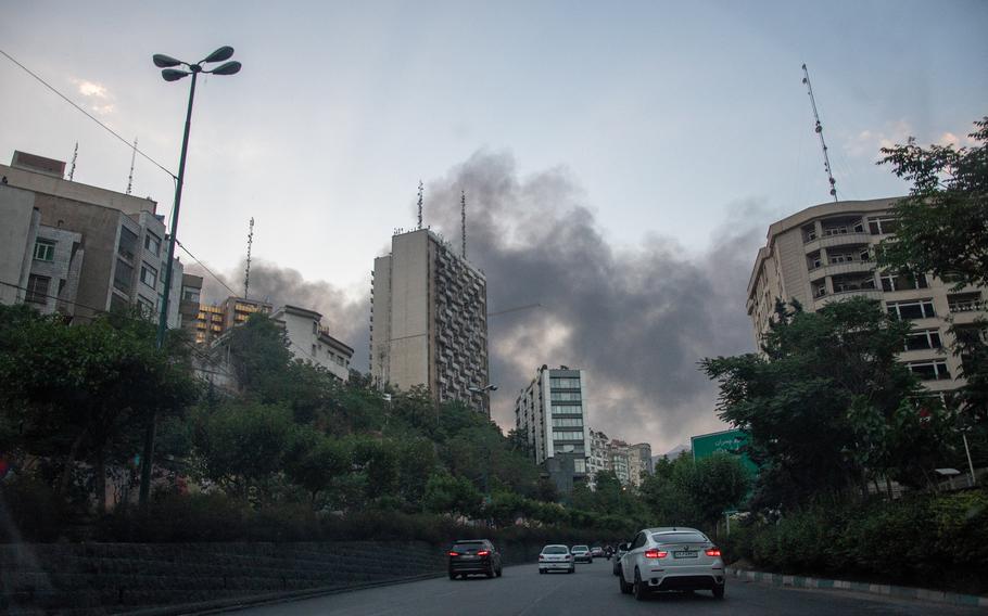 Smoke rises from the rubble of an Iranian state media building 