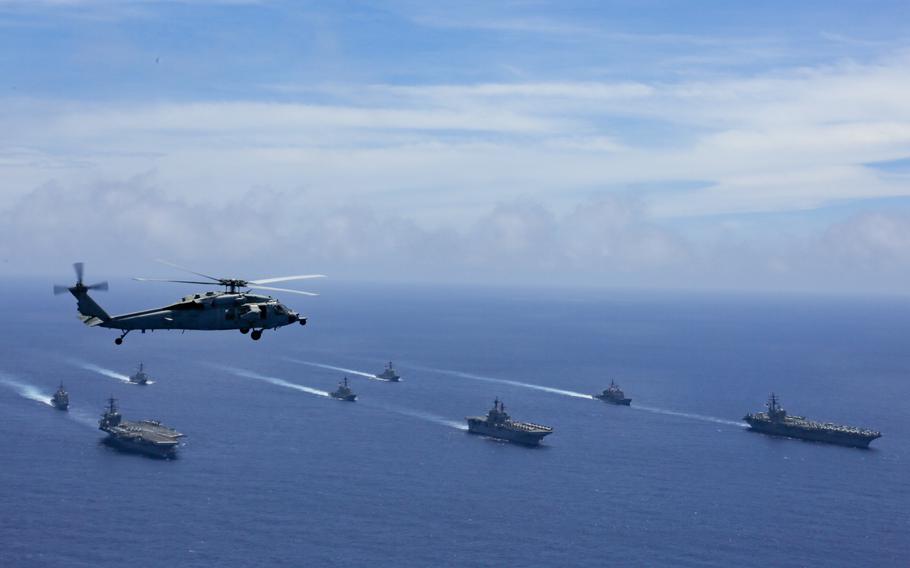 Ships with the USS Abraham Lincoln and USS Ronald Reagan aircraft carrier strike groups steam through the Philippine Sea during the Valiant Shield exercise on June 12, 2022. 