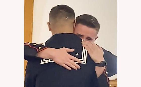 A video screen grab shows an emotional hug after Navy Seaman Nick Bliss, left, makes a surprise appearance at the wedding of his brother, Marine Lance Cpl. Cameron Bliss.