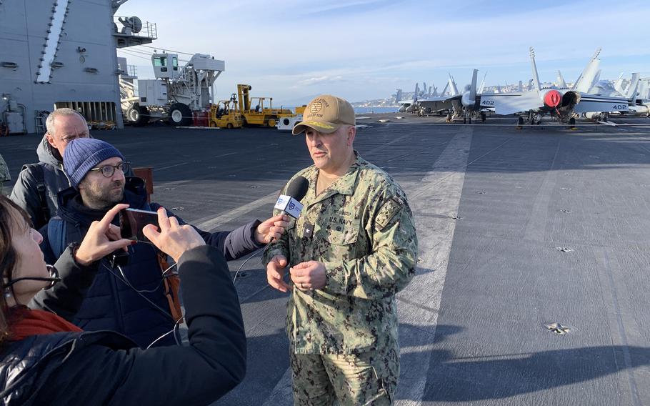 Rear Adm. Dennis Velez, commander of Carrier Strike Group 10, speaks to reporters aboard USS George H.W. Bush. The aircraft carrier was moored in the Bay of Naples for a port call on Nov. 29, 2022. 