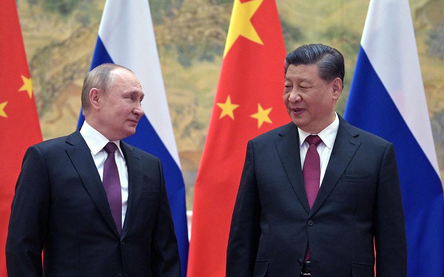 Russian President Vladimir Putin (left) and Chinese President Xi Jinping pose for a photograph during their meeting in Beijing on Feb. 4, 2022. 