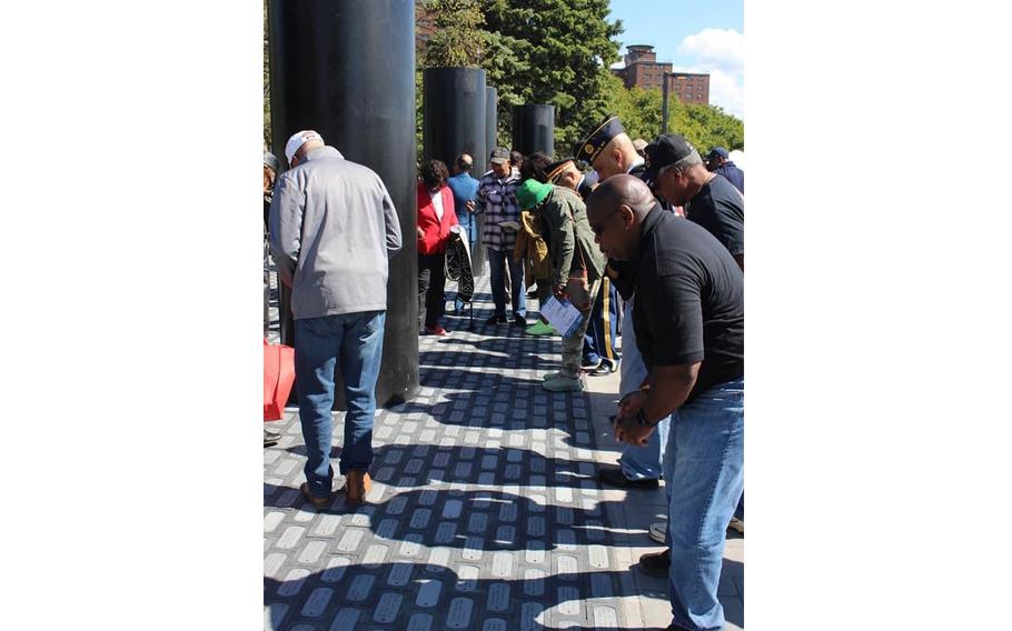 On opening day, visitors searched for loved ones' names inscribed in the brick paths at the African American Veterans Monument. 