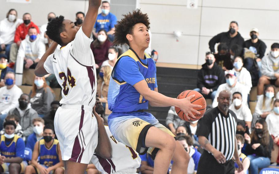 Wiesbaden's Devante' Benson goes up for a basket as Vilseck's Barkale Johnson defends in the third-place game at the DODEA-Europe Division I boys basketball tournament on Saturday, Feb. 26, 2022.