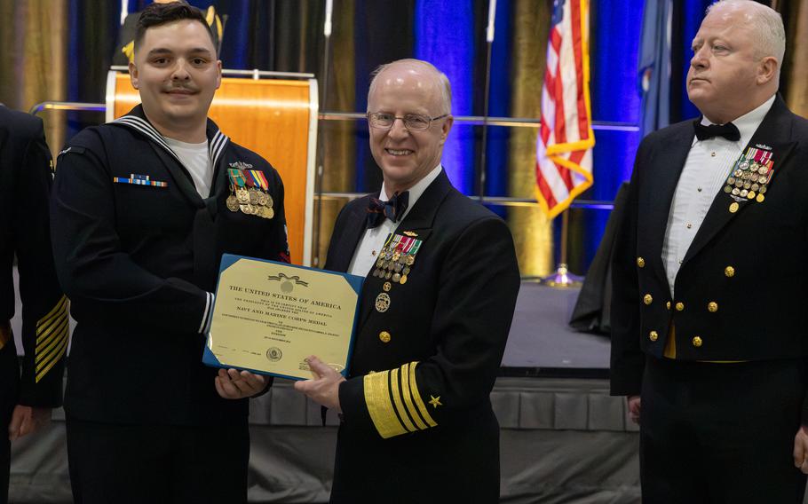 Adm. Daryl Caudle presents 1st Class Gabriel Journey with the Navy and Marine Corps Medal