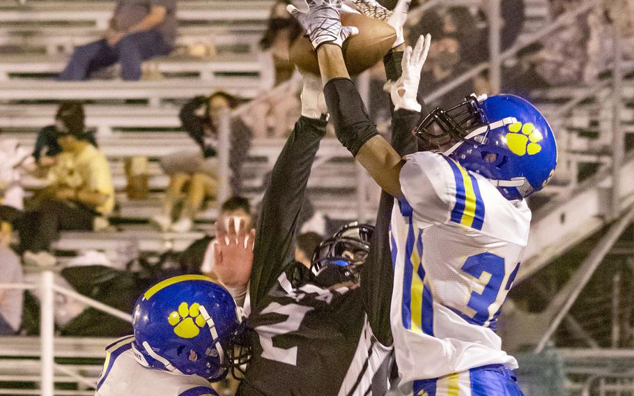 Zama receiver Keshawn McNeill and Yokota defender DeShawn Bryant go up for the ball.