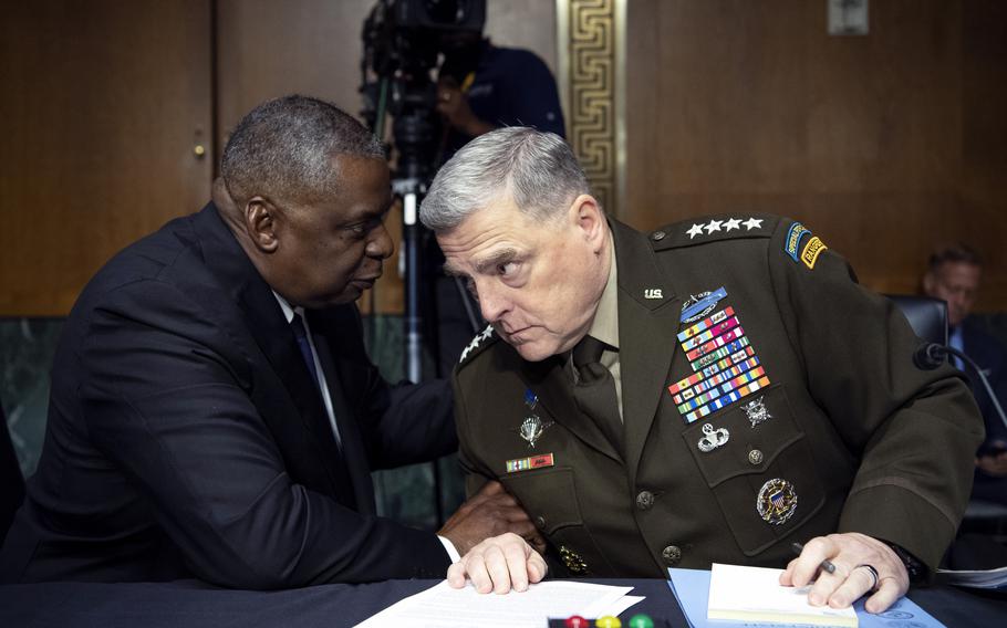 Defense Secretary Lloyd Austin, left, and Army Gen. Mark Milley, chairman of the Joint Chiefs of Staff, talk before a Senate Appropriations Committee hearing to examine proposed budget estimates and justification for fiscal year 2022 for the Defense Department in Washington on Thursday, June 17, 2021. 