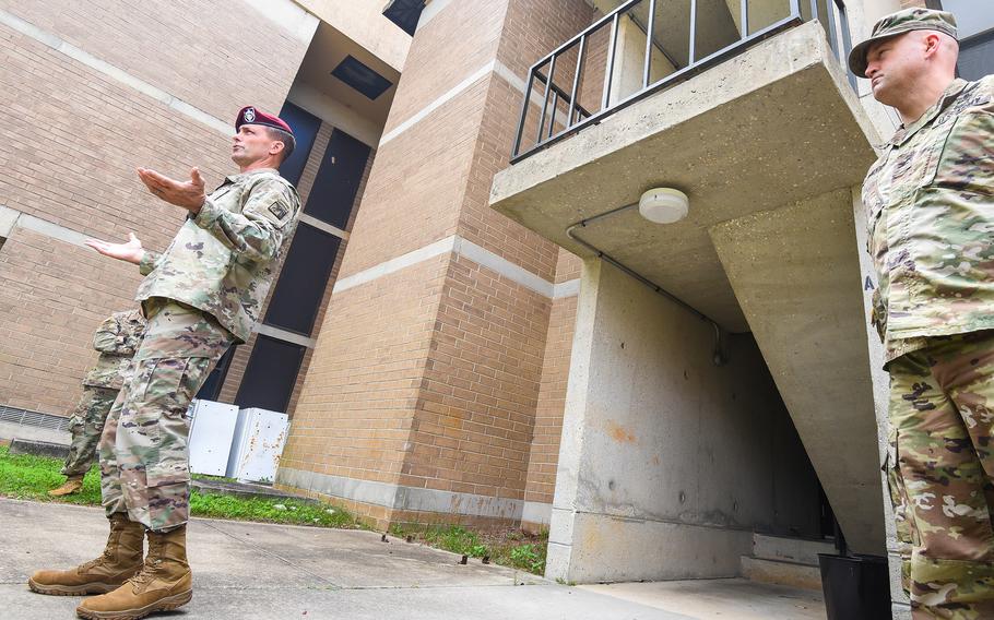 Maj. Gen. Brian Mennes, the deputy commander of the 18th Airborne Corps, speaks Thursday, Sept. 8, 2022 outside one of the Smoke Bomb Hill barracks at Fort Bragg, N.C. as Col. John Wilcox, the post’s garrison commander, looks on. Army leaders are working to move some 1,200 soldiers out of the 1970s-era barracks after problems with mold and insufficient air conditioning worsened this summer, post officials said. 