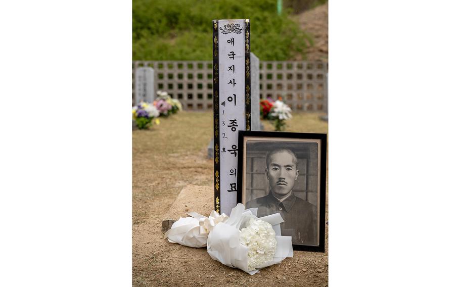 A portrait of Lee Jong-wook sits in front of his burial site at Daejeon National Cemetery in South Korea. 